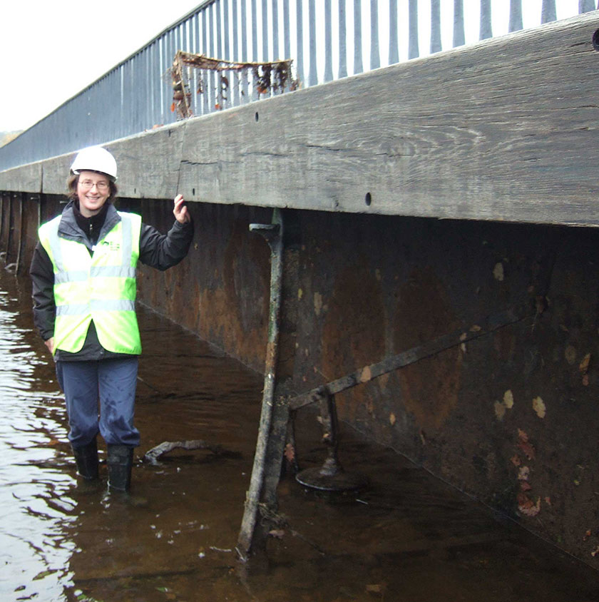 Empty trough and archaeologist next to plug